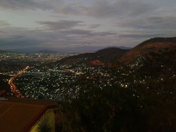 Aerial view of illuminated cityscape against sky at dusk