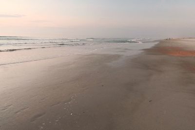 Scenic view of beach against sky during sunset