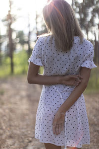 Rear view of woman with umbrella standing on land