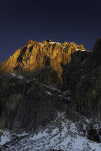 Scenic view of snowcapped mountains against clear blue sky