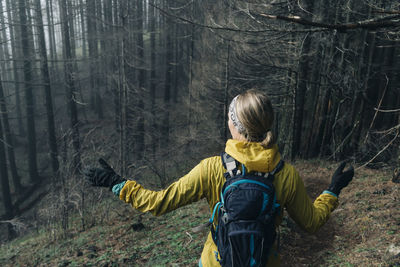 A young woman hikes along a trail in a forest in cascade locks, or.