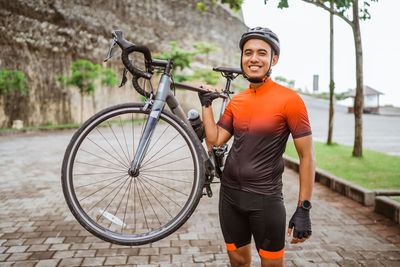 Low section of man riding bicycle on street