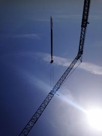 Low angle view of crane against sky