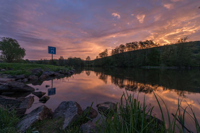 Scenic view of lake against sky during sunset