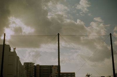 Low angle view of building against cloudy sky