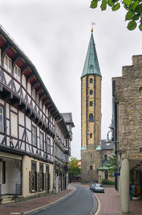 Street amidst buildings in city against sky