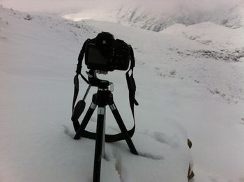 Close-up of camera on snow covered land