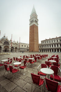 Clock tower against buildings in city