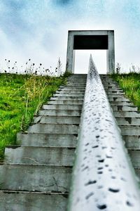 Built structure on field against sky