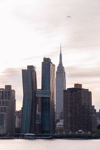 View of skyscrapers against cloudy sky