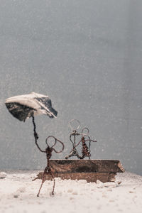 Old metal structure on sand during winter