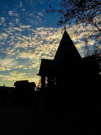 Low angle view of silhouette buildings against sky