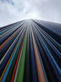 Low angle view of multi colored metallic structure against sky