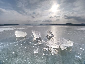 Melting of pieces of thick ice on frozen sea. hot sun begun thaw of glacier