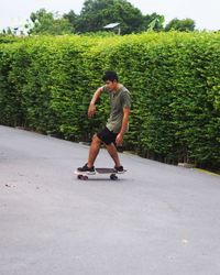 Side view of man exercising on road