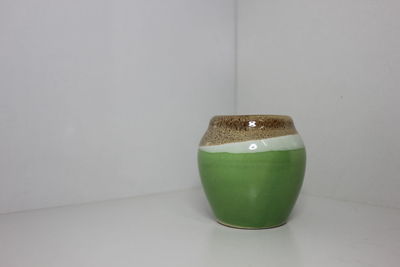 Close-up of drink on table against white background