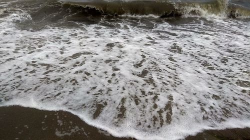 High angle view of waves breaking on shore