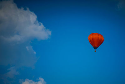 Low angle view of hot air balloon against blue sky