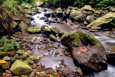 High angle view of stream flowing through rocks