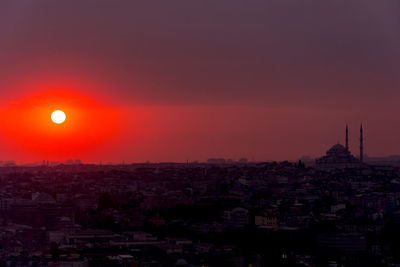 Silhouette buildings against sky during sunset