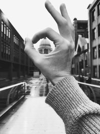 Midsection of person holding umbrella in city