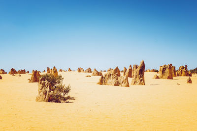 Panoramic view of desert against clear sky