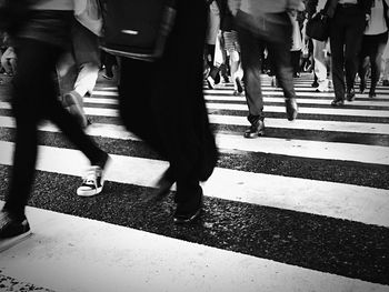 Low section of people walking on road