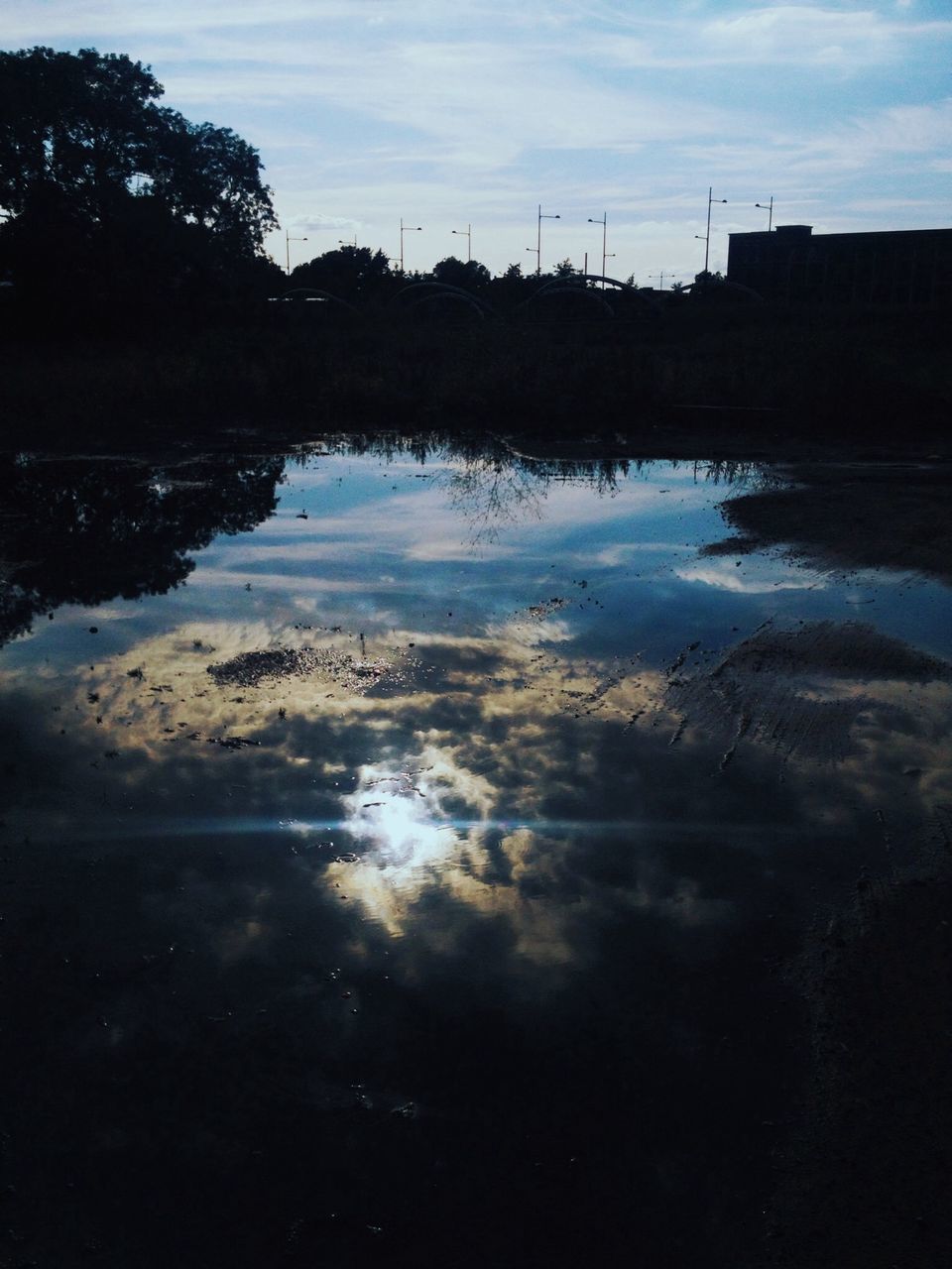 water, reflection, sky, lake, silhouette, tranquility, tranquil scene, cloud - sky, scenics, waterfront, beauty in nature, nature, puddle, cloud, sunset, standing water, dusk, tree, outdoors, calm