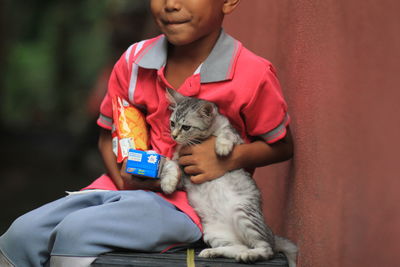 Full length of a boy with cat