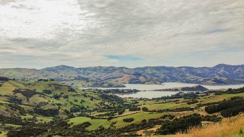 Scenic view of landscape and mountains against sky