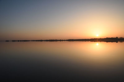 Scenic view of lake against sky during sunset