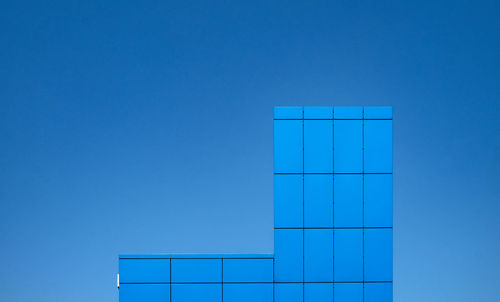 Low angle view of building against clear blue sky