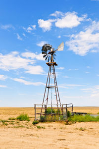 Windmill on field against sky