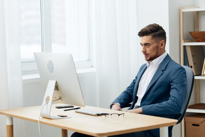 Young man using laptop at home