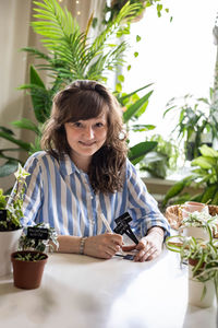 Portrait of young woman sitting on table