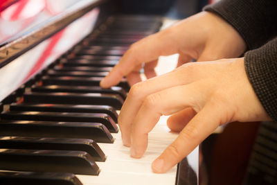 Close-up of hands playing piano