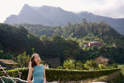 Portrait of woman standing in mountains