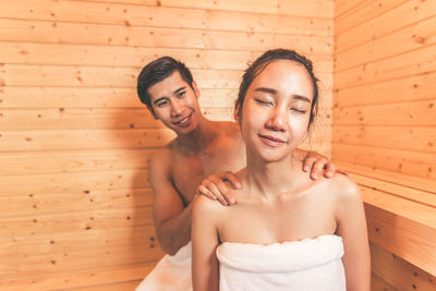 Young couple sitting in sauna