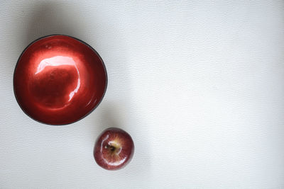 Close-up of red fruit over white background