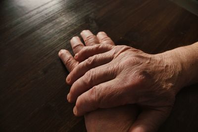 Close-up of hands on table