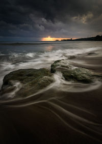 Scenic view of sea against cloudy sky