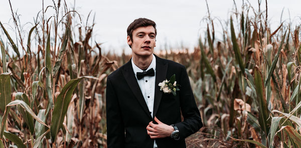 Portrait of bridegroom standing on land