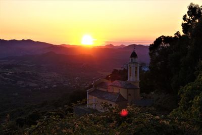Scenic view of buildings against sky during sunset