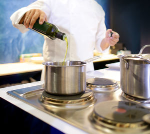 Midsection of man preparing food in kitchen