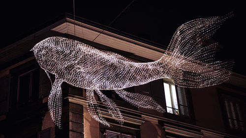 Low angle view of illuminated building at night