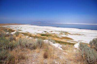 Scenic view of sea against clear blue sky