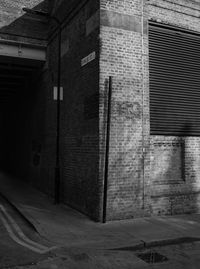 Empty road by buildings in city