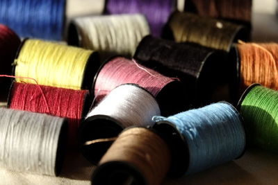 Close-up of colorful spools of thread on fabric