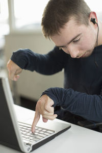 Disabled businessman using laptop in office