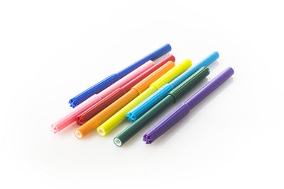 Close-up of colorful colored pencils against white background